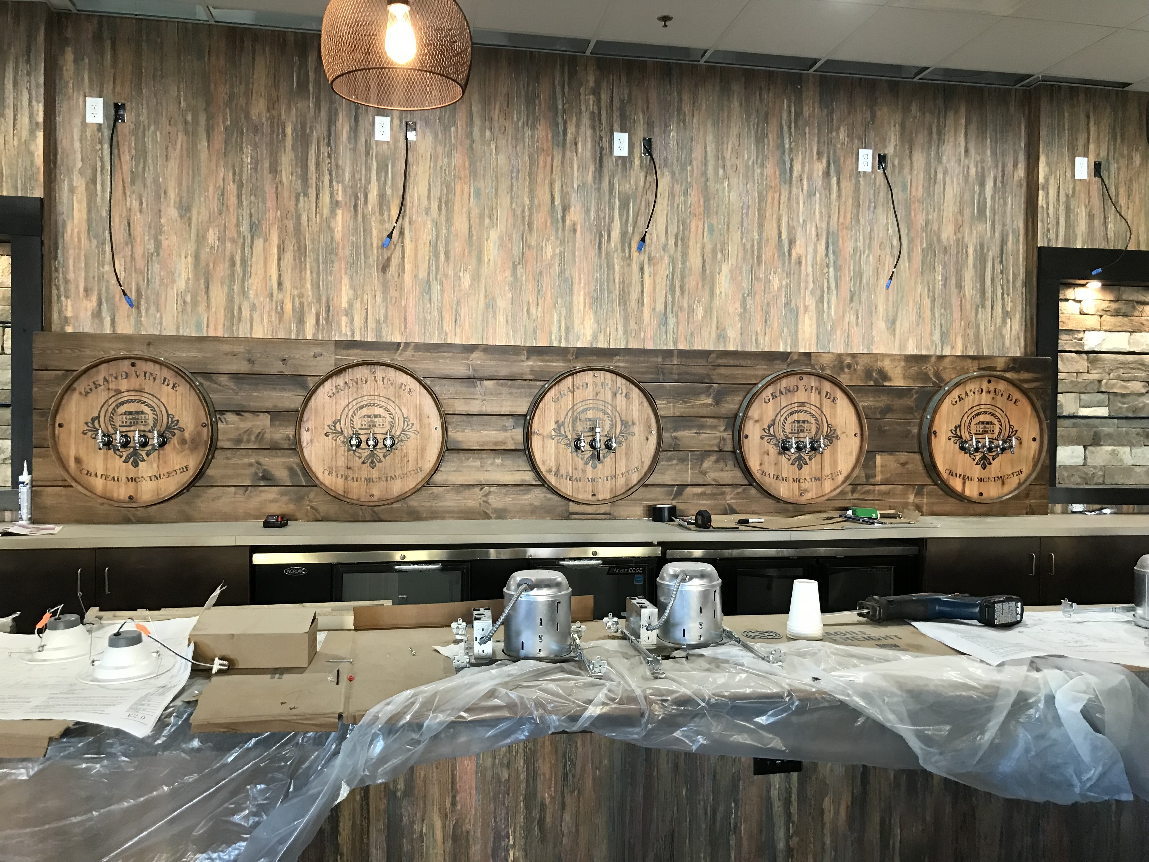 Bar with decorative wine barrel tap facades under construction
