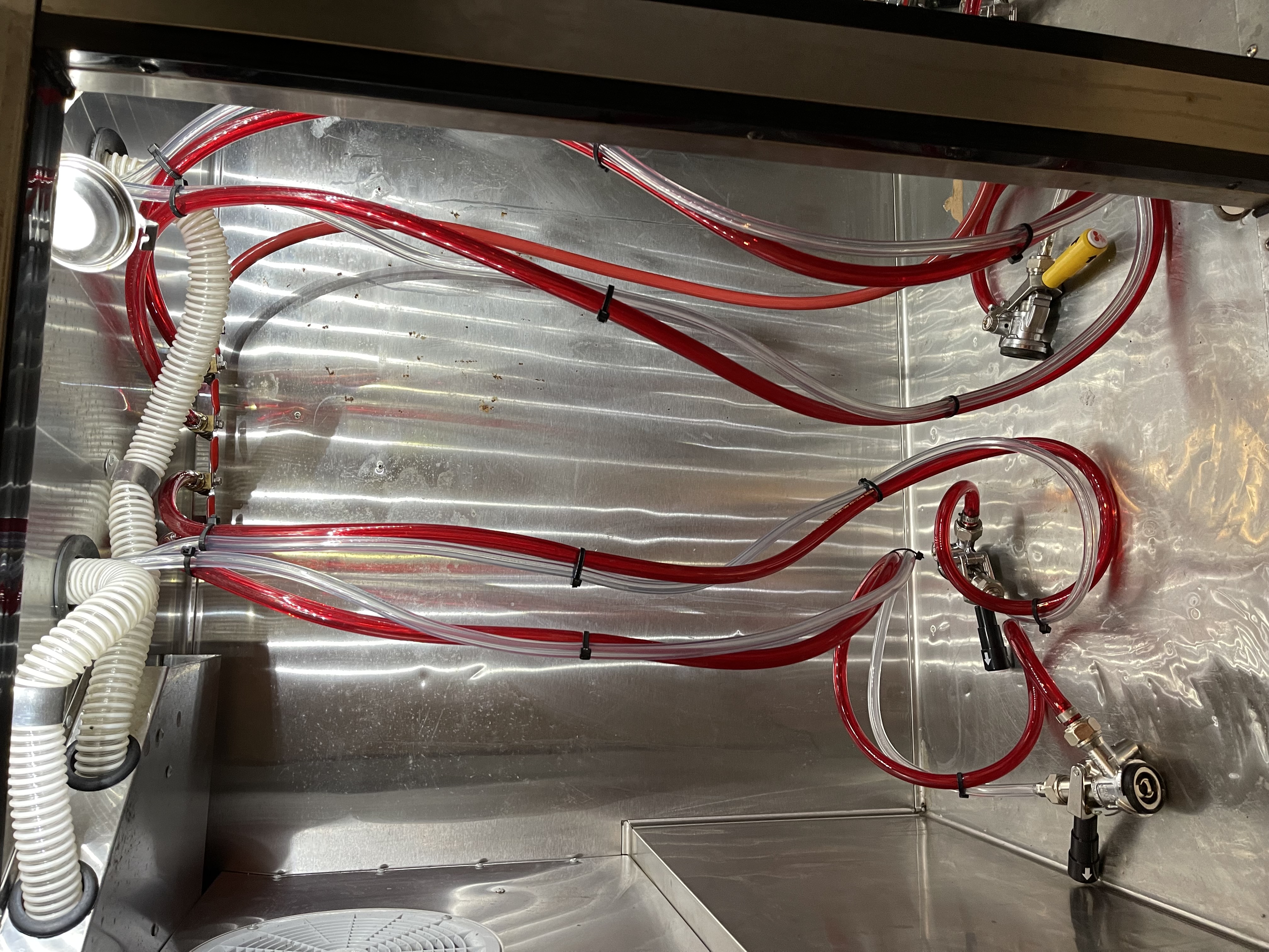 Glycol trunk line cooler with red and clear beer lines and keg couplers