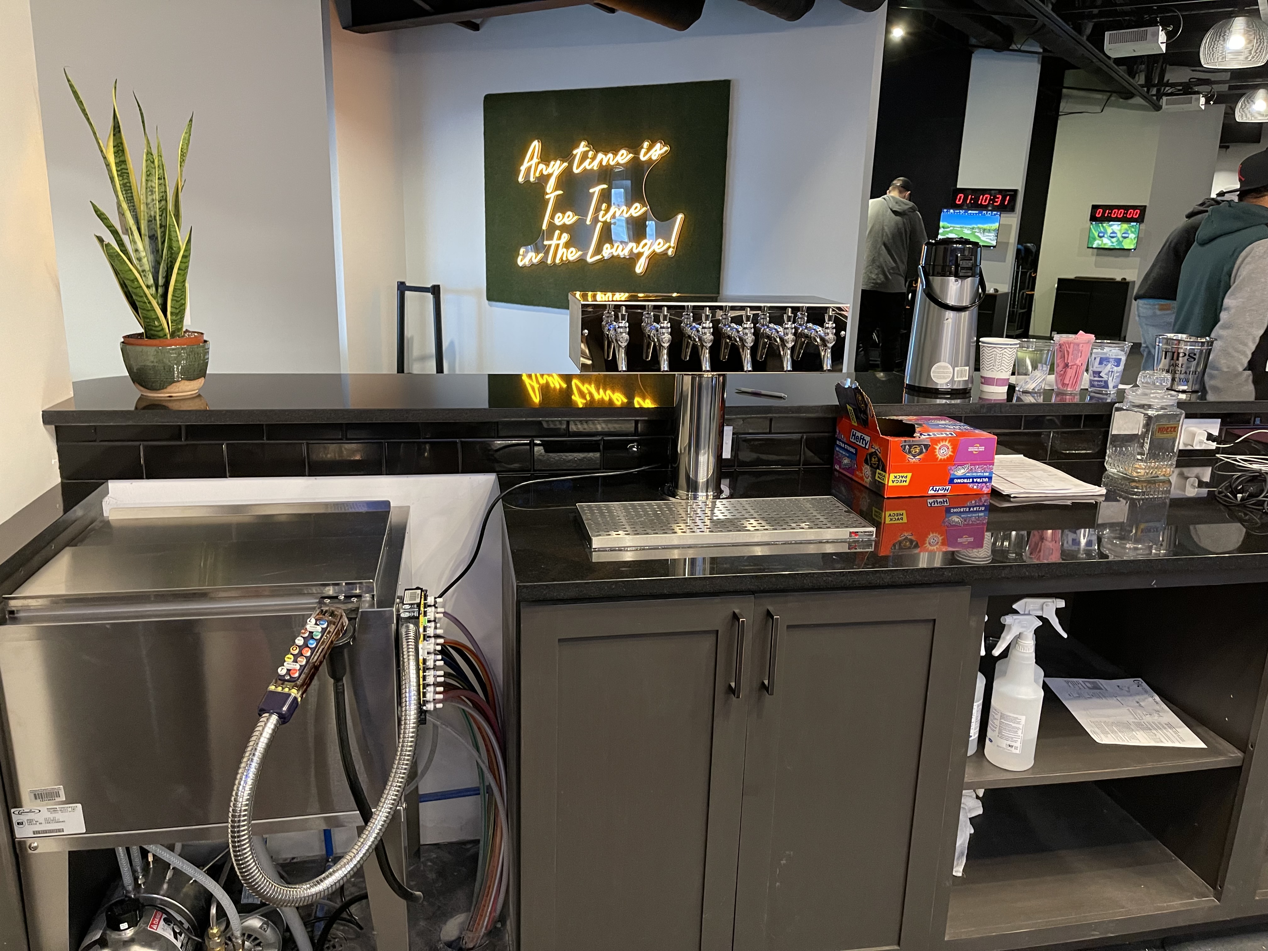 Golf lounge bar with neon sign and 10-tap tower