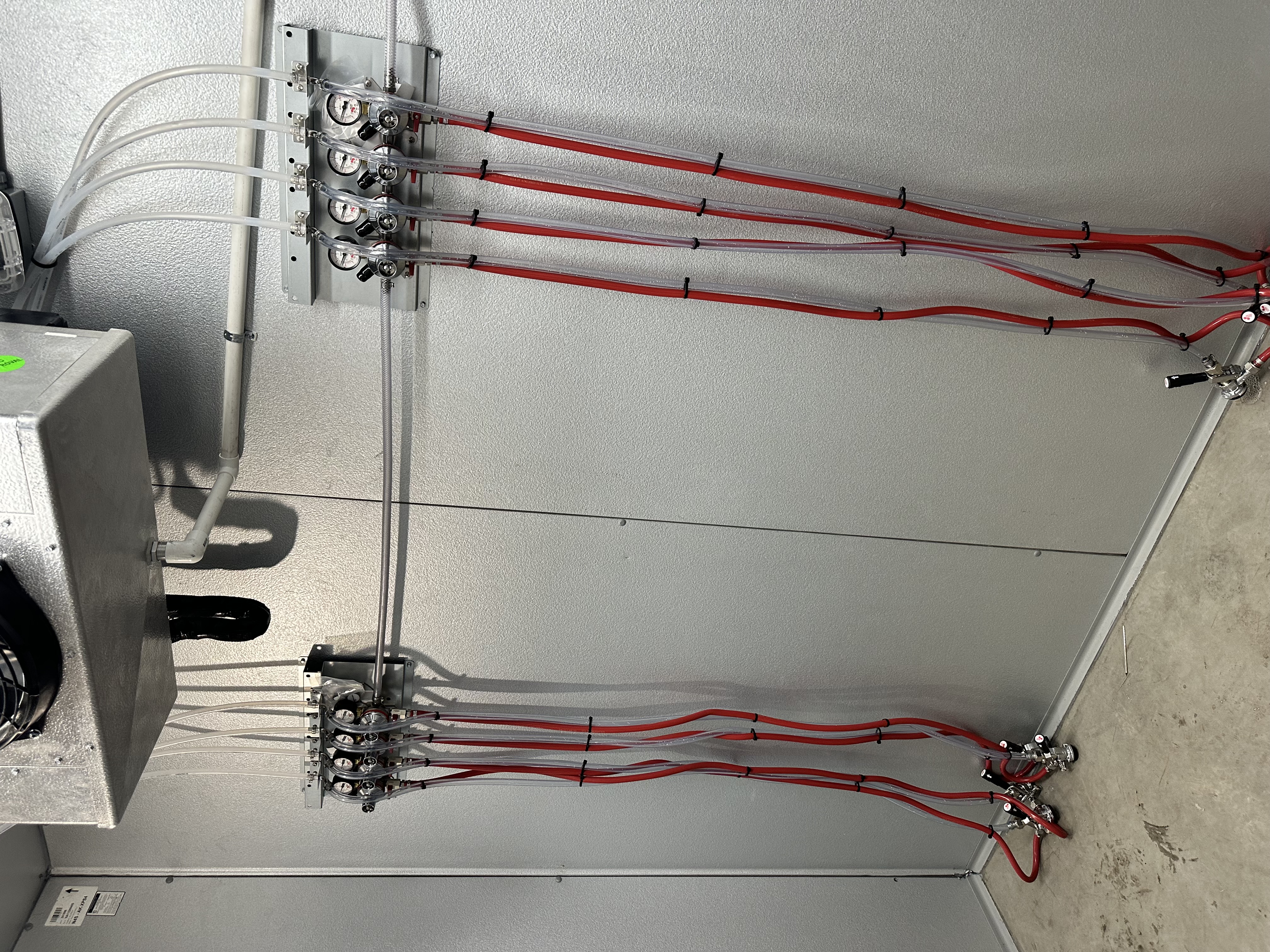 Walk-in cooler wall with secondary CO2 regulators and bundled tubing