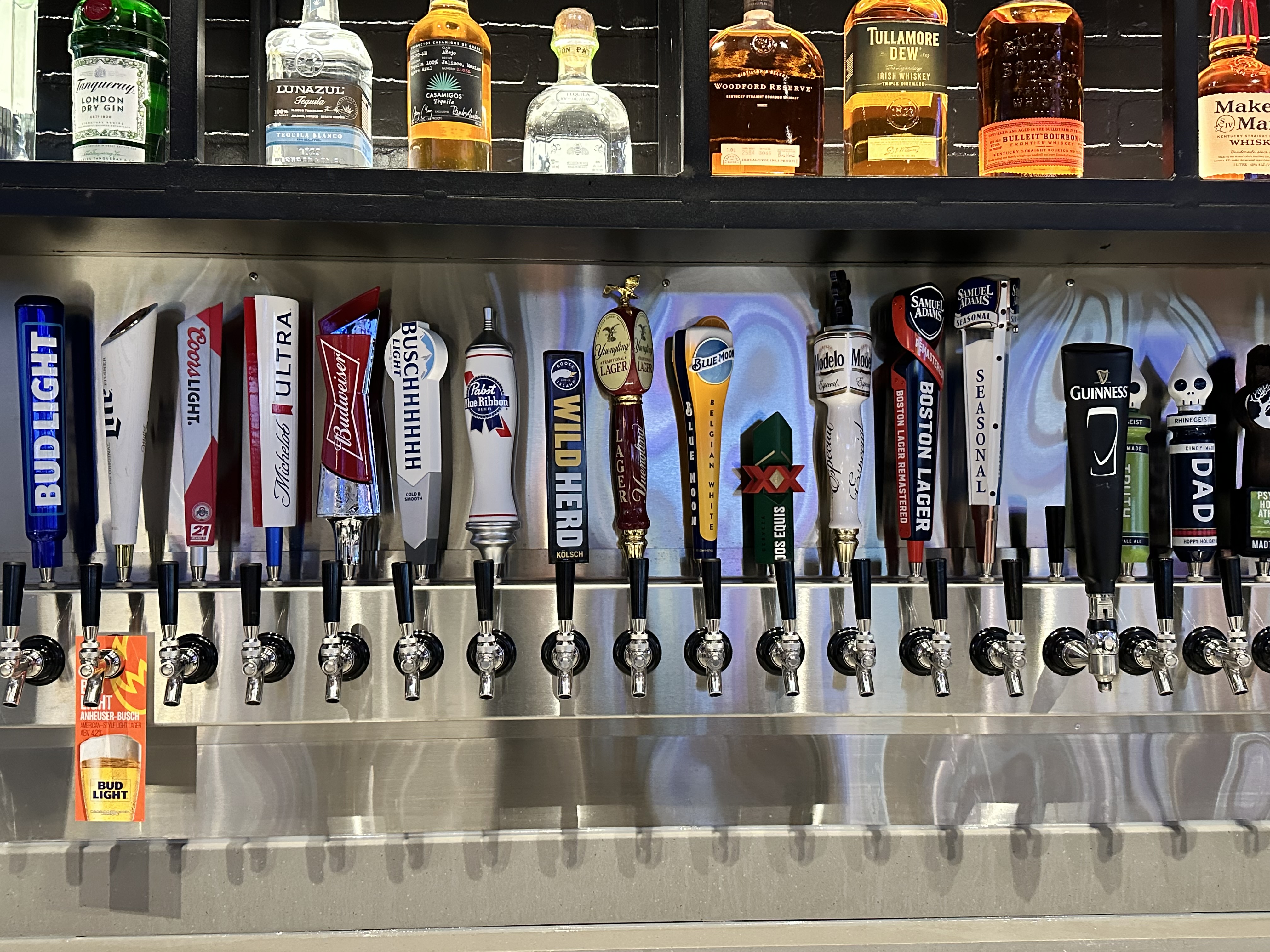 Large bar with over 20 branded draft beer tap handles installed by Superior Draft